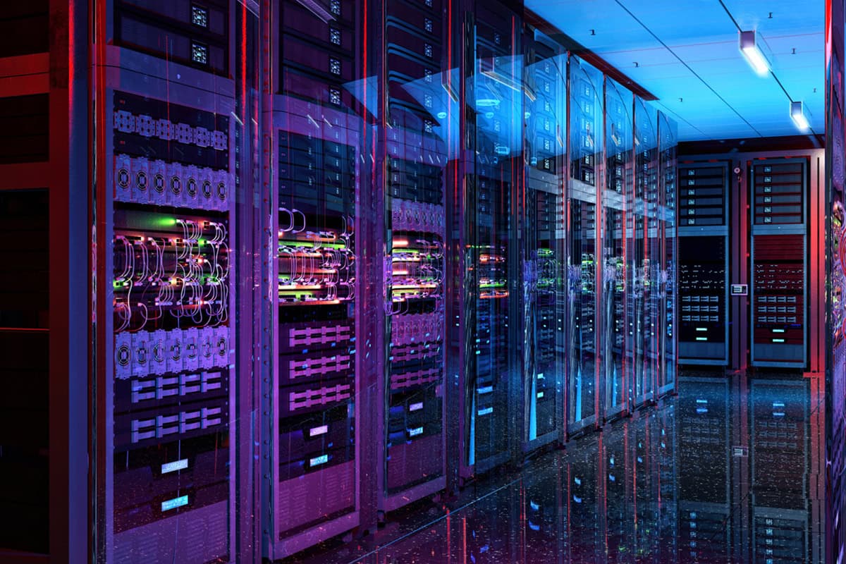 A corridor of server racks in a data center, lit in purple, red and blue, with cabling visible through glass-fronted cabinets